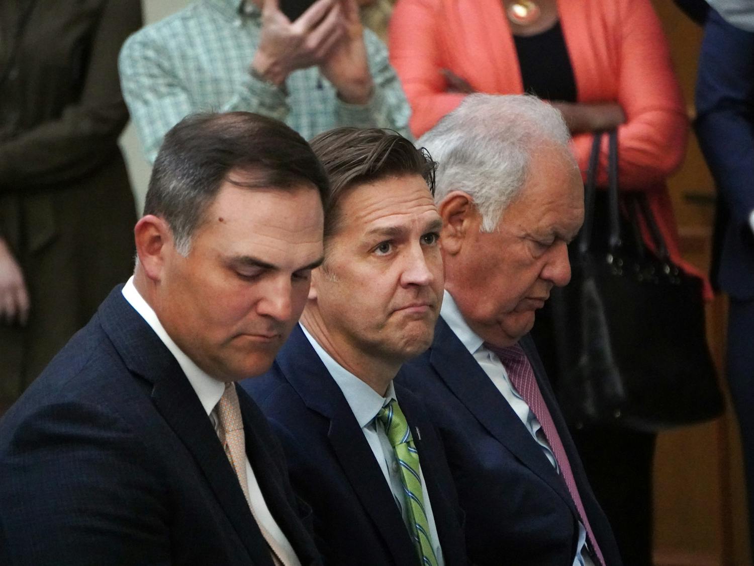 New UF president Ben Sasse sits between Patrick Zalupski (left) and Mori Hosseini (right) during a press conference at Jacksonville City Hall Tuesday, Feb. 7, 2023.