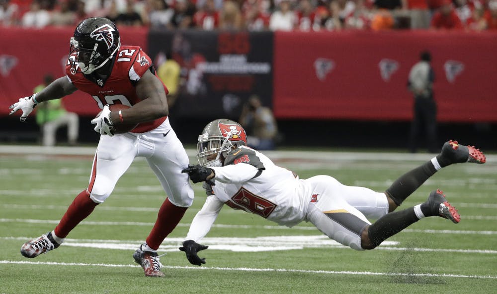 <p>Atlanta Falcons wide receiver Mohamed Sanu (12) moves past Tampa Bay Buccaneers cornerback Vernon Hargreaves (28) during the second half of an NFL football game, Sunday, Sept. 11, 2016, in Atlanta. (AP Photo/David Goldman)</p>