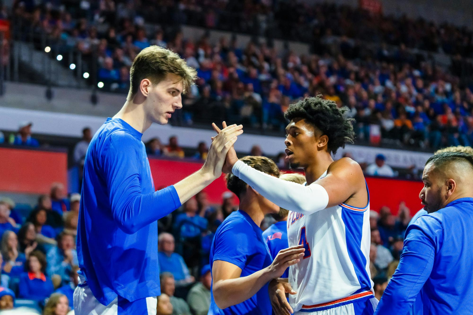 UF basketball player Olivier Rioux (32) high-fives teammate Sam Alexis (4) during the game against the Tennessee Volunteers on Jan. 7, 2025.
