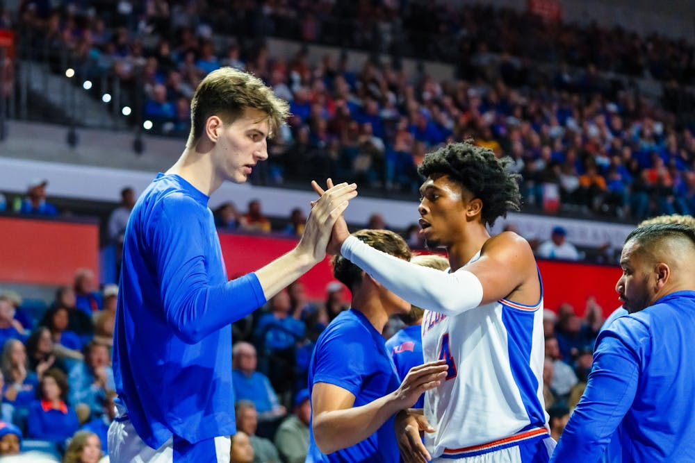 <p>UF basketball player Olivier Rioux (32) high-fives teammate Sam Alexis (4) during the game against the Tennessee Volunteers on Jan. 7, 2025.</p>