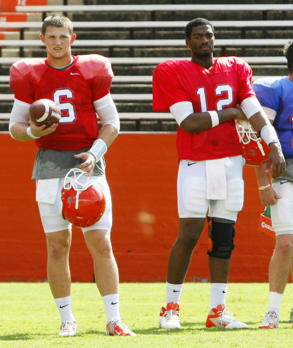 <p>Jeff Driskel (6) and Jacoby Brissett (12) watch over open practice Aug. 18 at Ben Hill Griffin Stadium.</p>