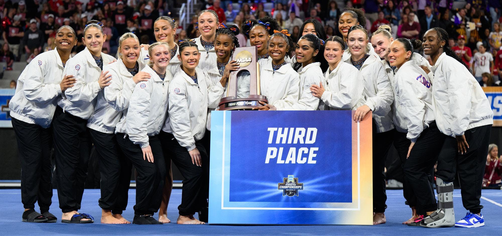 The Gators pose and hold their third place trophy after the NCAA gymnastics National Championship against Oklahoma, LSU and Minnesota, Saturday, April 18, 2026, in Fort Worth, Texas.