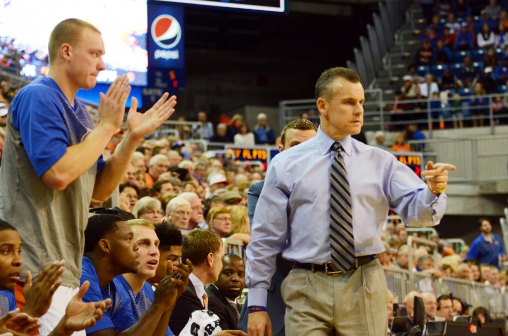 Billy Donovan looks down the court while players celebrate during Florida's 72-47 win against Mississippi State on Saturday in the O'Connell Center