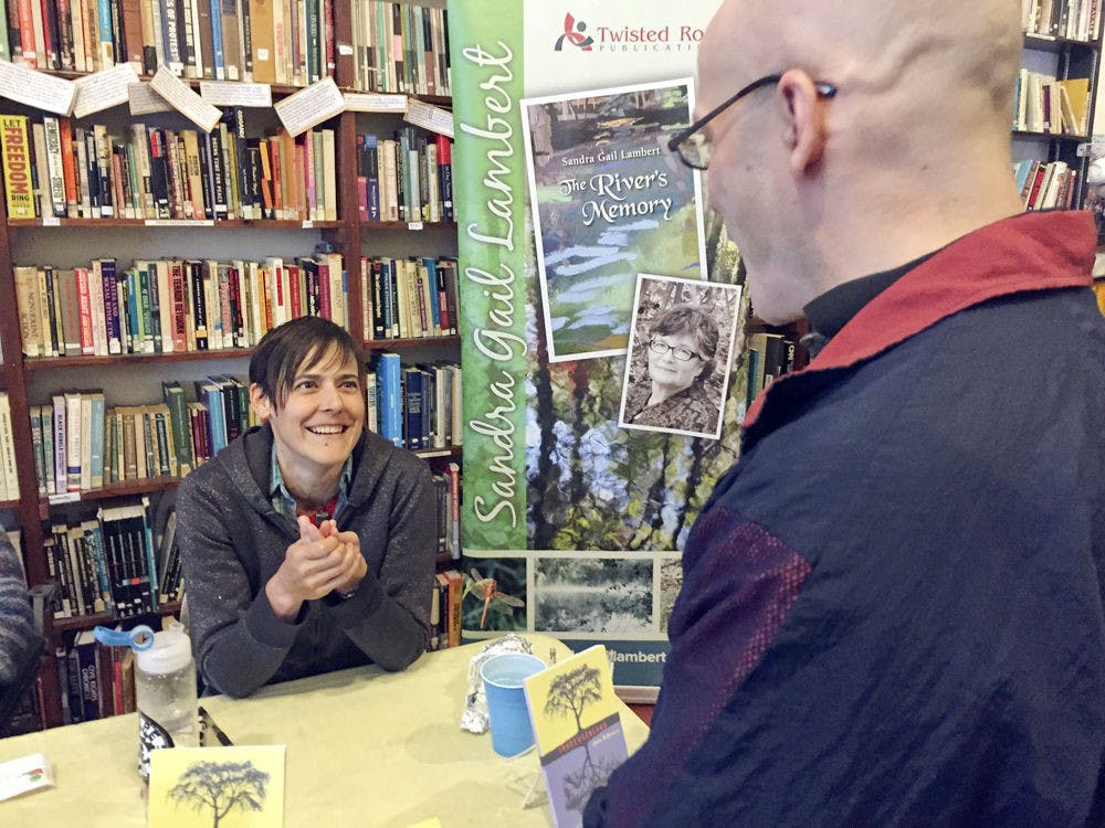 Author Jacks McNamara, 34, talks with Dave O’Gorman, 45, at Read Local about McNamara’s book titled “Inbetweenland.”