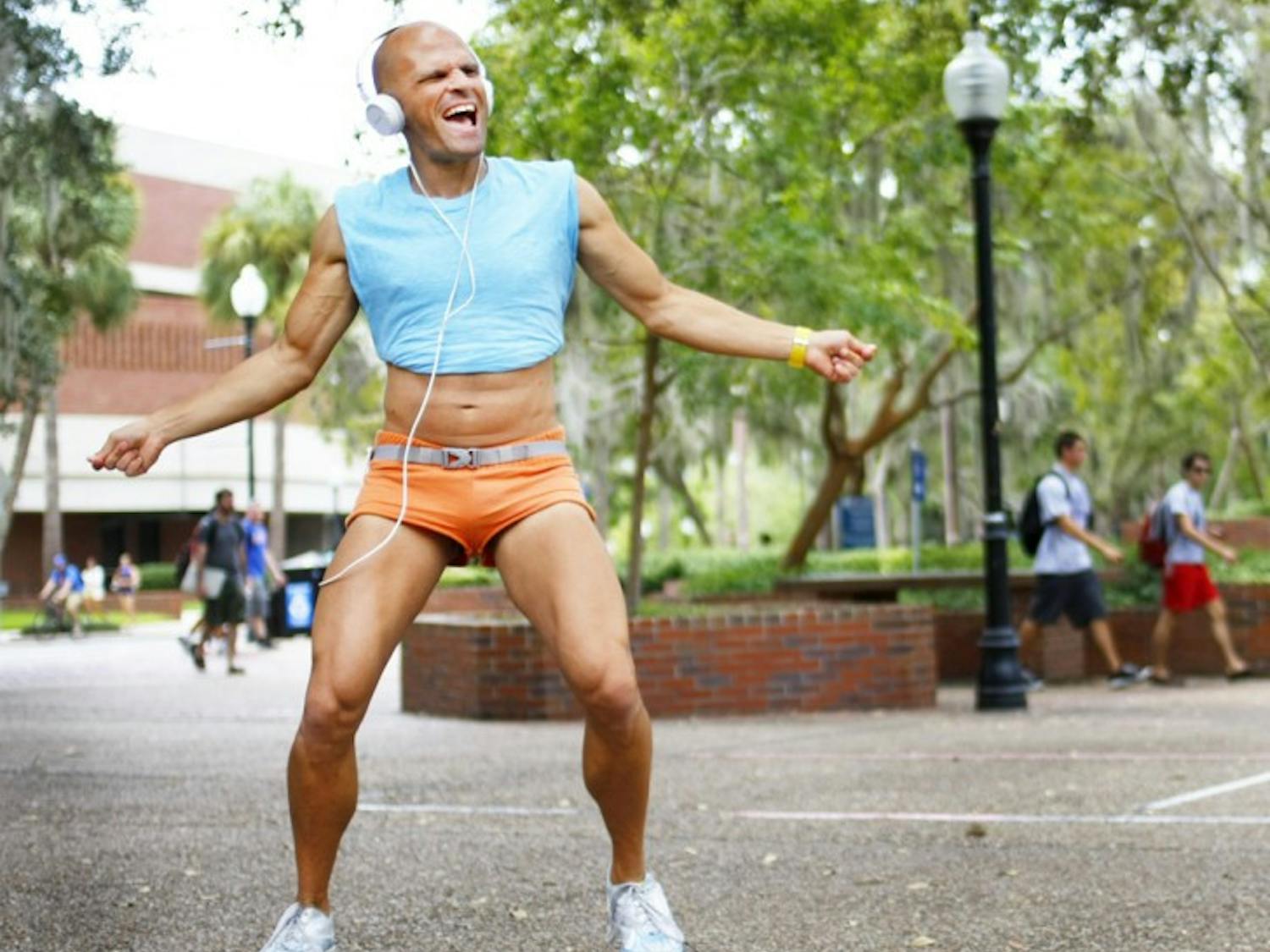 Dennis Kane, 36, dances on Turlington Plaza on Wednesday afternoon. From 9 a.m. to 3 p.m. students can catch Kane waving his arms while listening to music on the plaza.