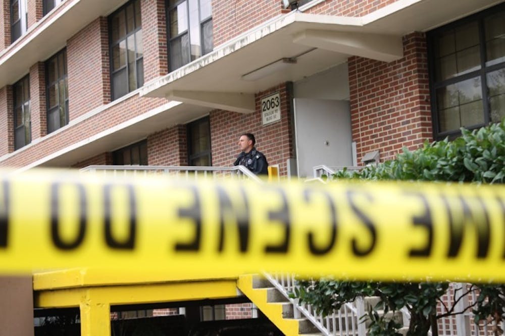<p>UPD officer John Savona stands behind police tape at North Hall where a student attempted suicide on Wednesday afternoon, according to police.</p>