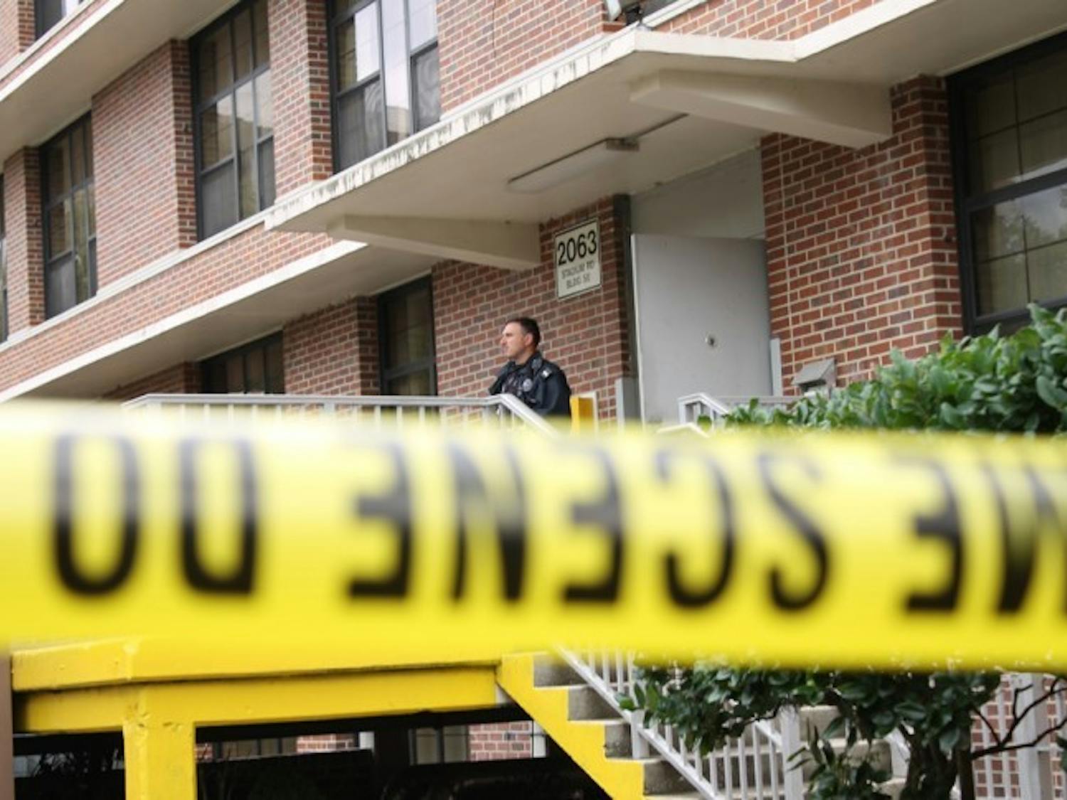 UPD officer John Savona stands behind police tape at North Hall where a student attempted suicide on Wednesday afternoon, according to police.