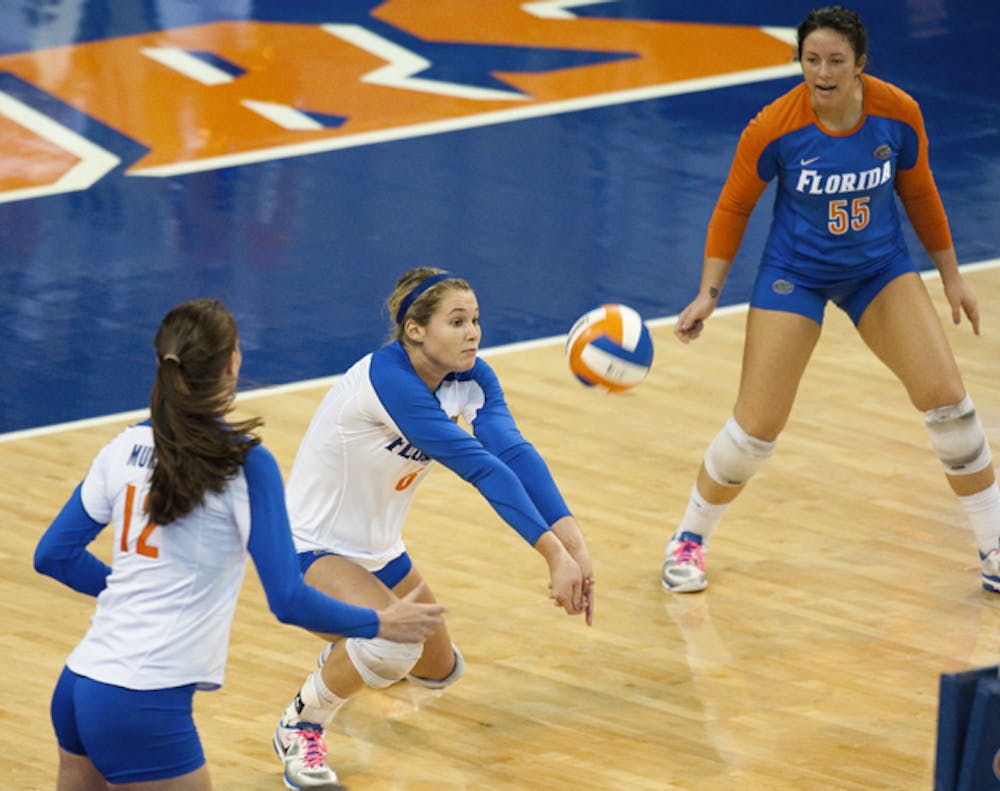 <p>Florida outside hitter Kristy Jaeckel (center) and right-side hitter Kelly Murphy (left), both seniors, combined for 57 kills in the Gators’ first- and second-round victories in the NCAA championship.</p>