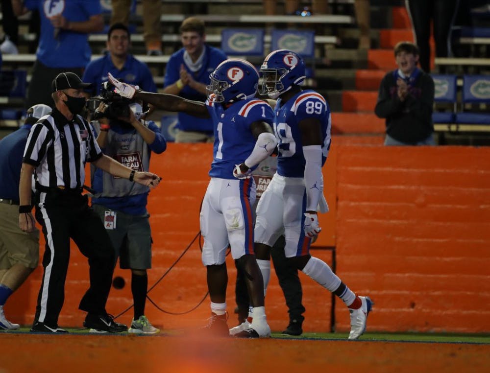 Kadarius Toney (1) and receiver Justin Shorter (89) celebrate a score in Saturday's win against Missouri.