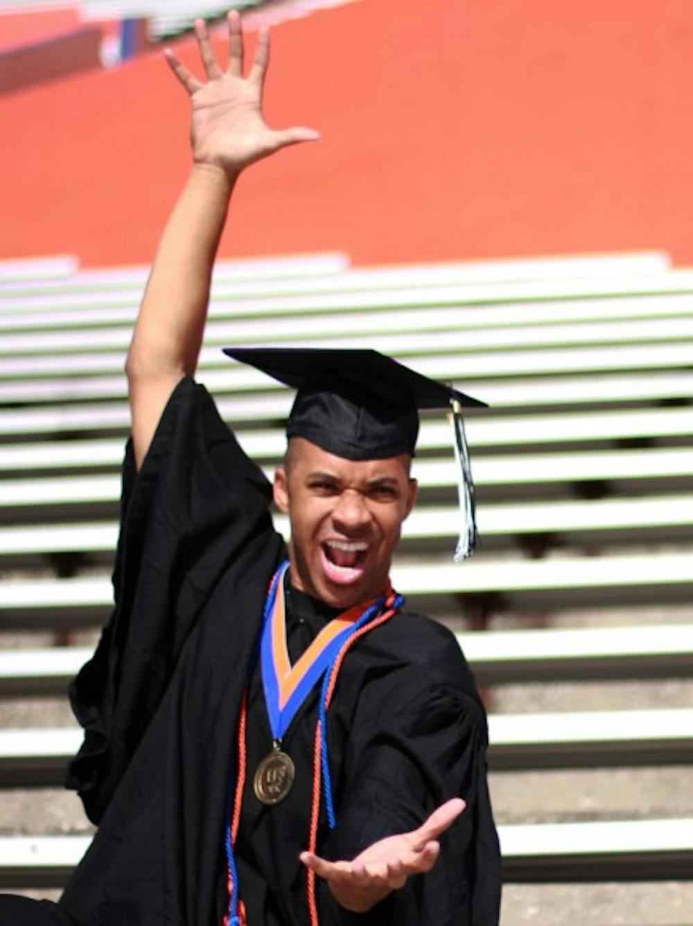 <p>UF graduate Cameron "Scooter" Magruder, 23, poses for a graduation picture in Ben Hill Griffin Stadium.</p>