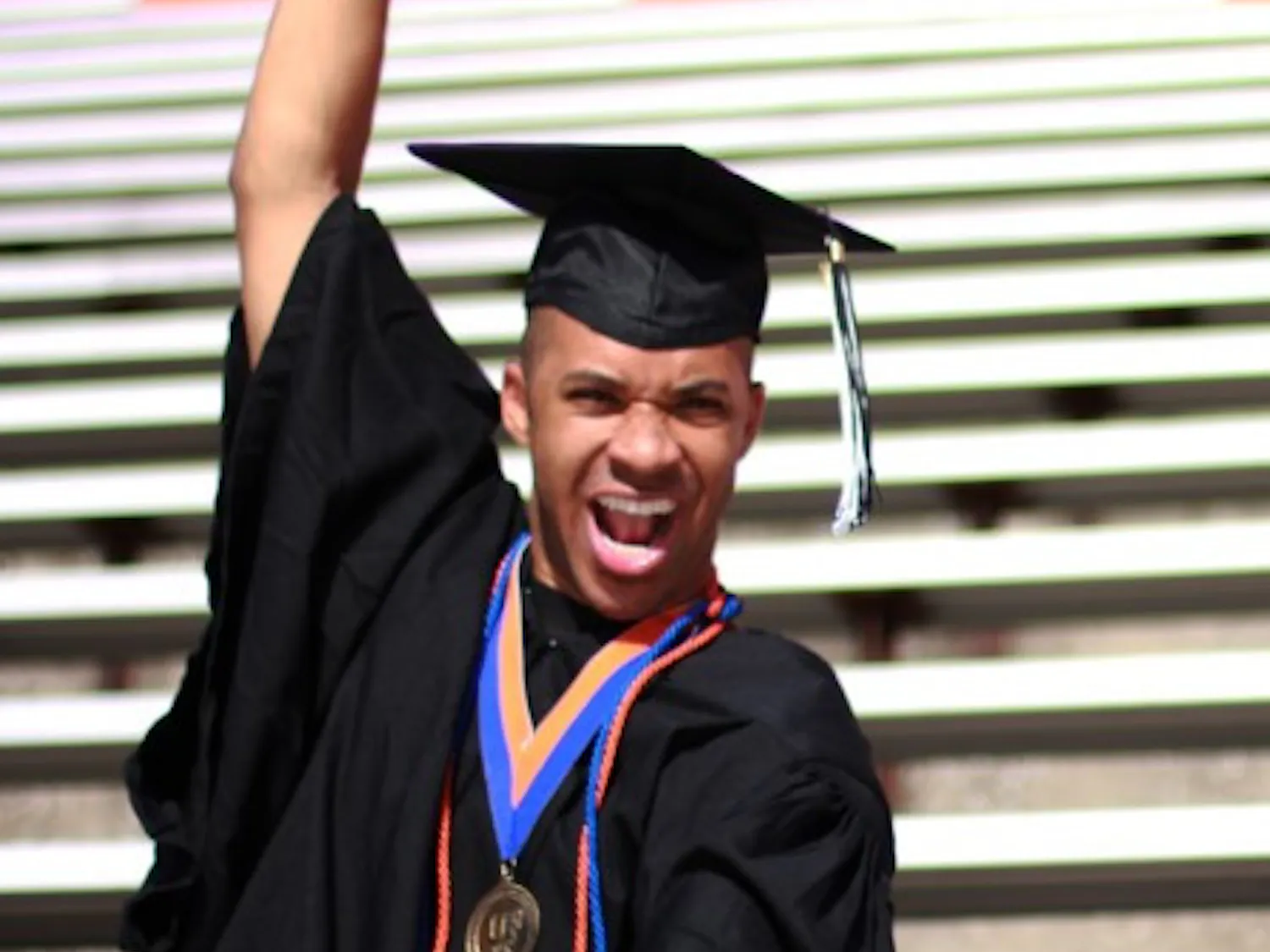 UF graduate Cameron "Scooter" Magruder, 23, poses for a graduation picture in Ben Hill Griffin Stadium.