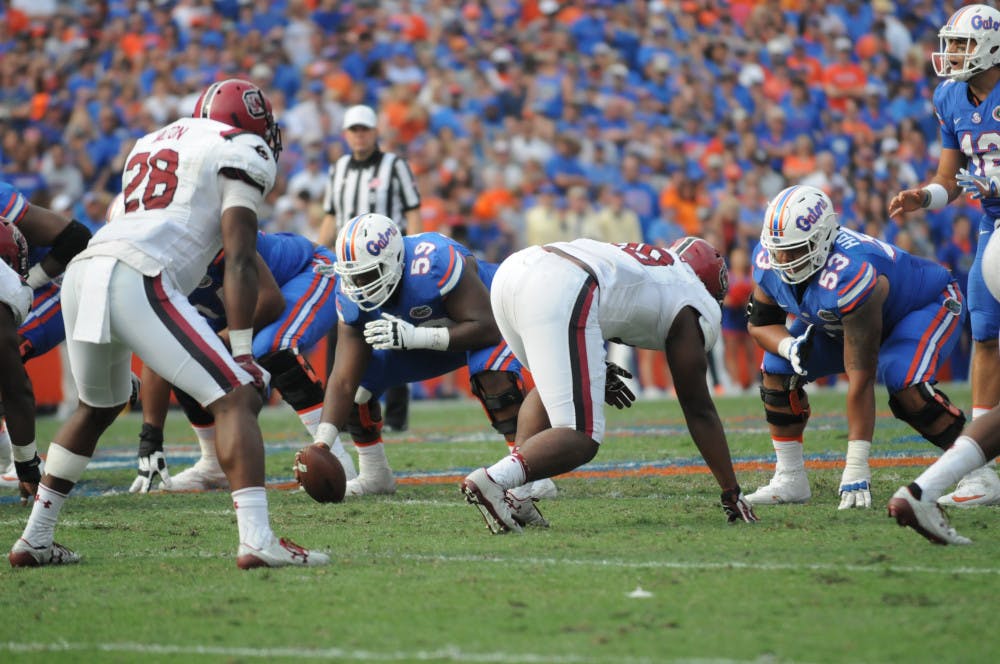 <p>T.J. McCoy (59) prepares to snap the ball during Florida's win against South Carolina on Nov. 12, 2016, at Ben Hill Griffin Stadium.</p>