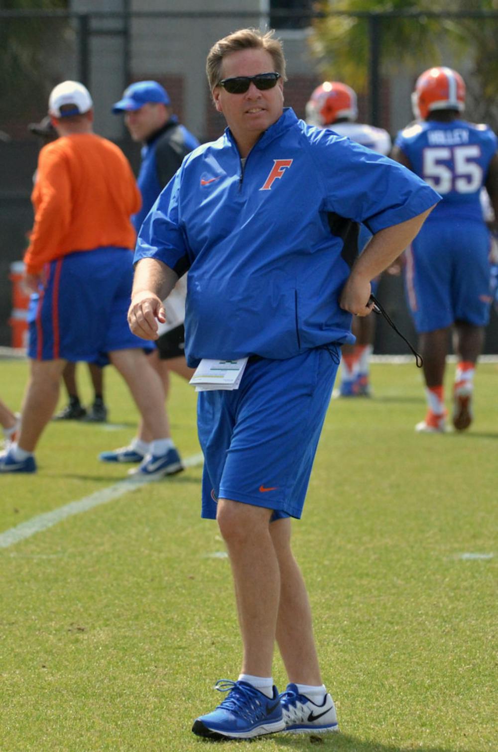 <p>Jim McElwain watches on during practice on April 6 at Donald R. Dizney Stadium.</p>