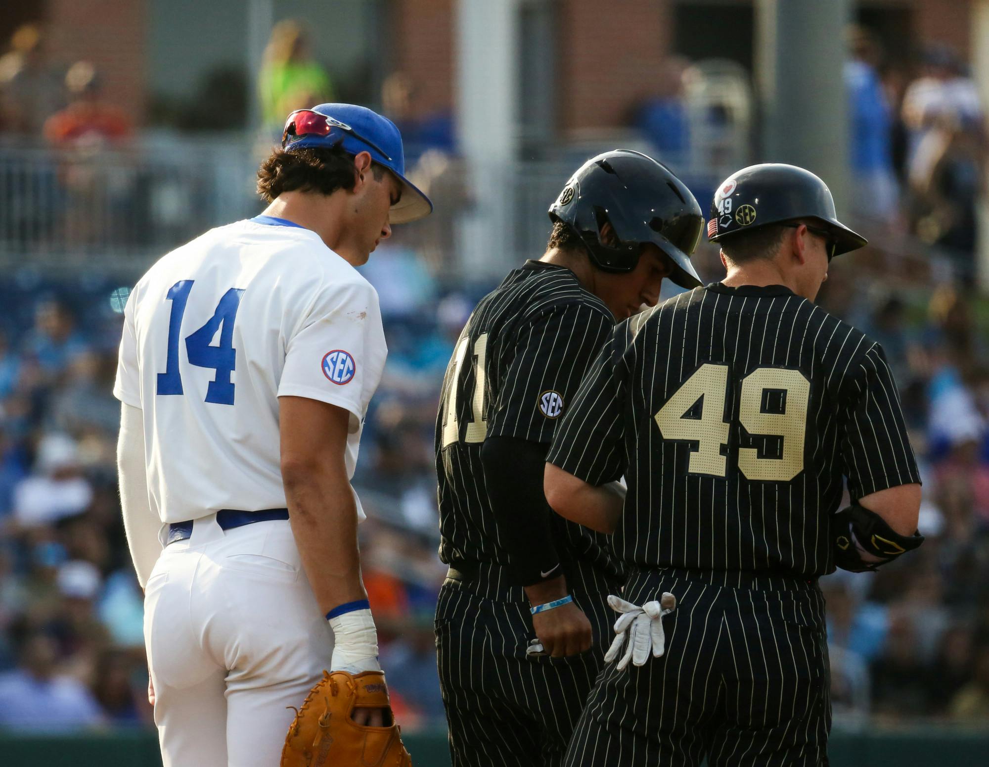 Florida sophomore Jac Caglianone looks over the shoulders of Vanderbilt players during the Gators' 10-0 victory against the Commodores Friday, May 12, 2023. 
