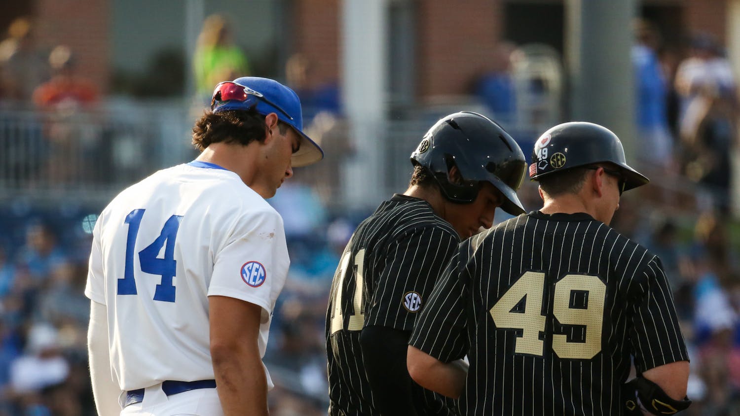 Florida sophomore Jac Caglianone looks over the shoulders of Vanderbilt players during the Gators' 10-0 victory against the Commodores Friday, May 12, 2023. 