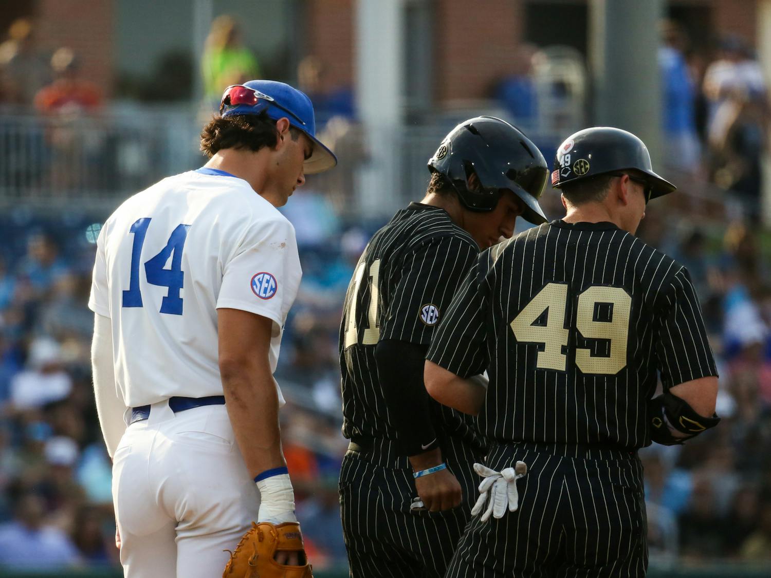 Florida sophomore Jac Caglianone looks over the shoulders of Vanderbilt players during the Gators' 10-0 victory against the Commodores Friday, May 12, 2023. 