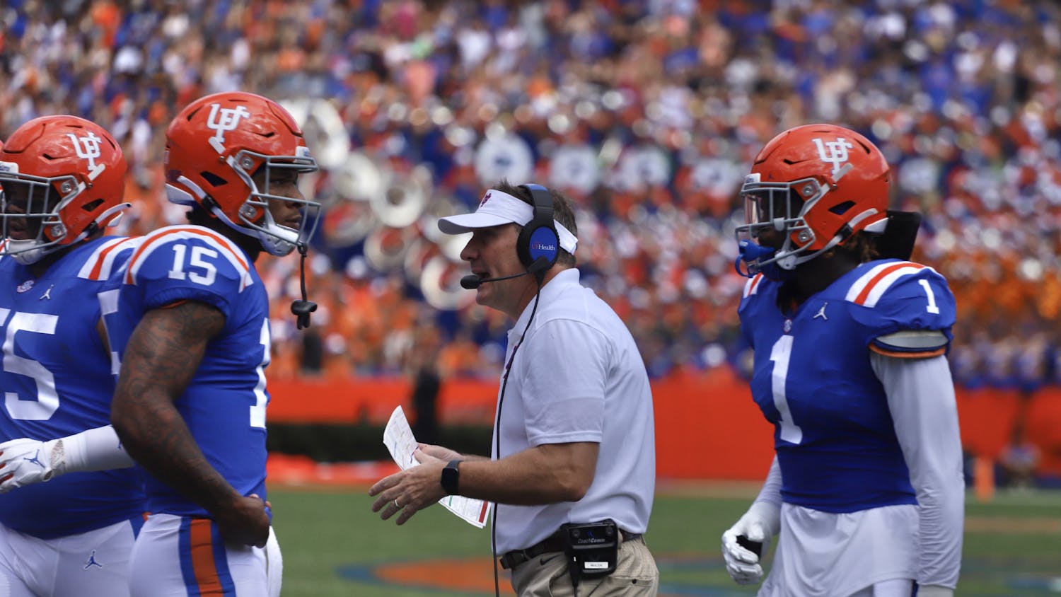Florida head coach Dan Mullen on the sideline with Anthony Richardson (15) and Brenton Cox Jr. (1) during Florida's Oct. 16 game against Vanderbilt.