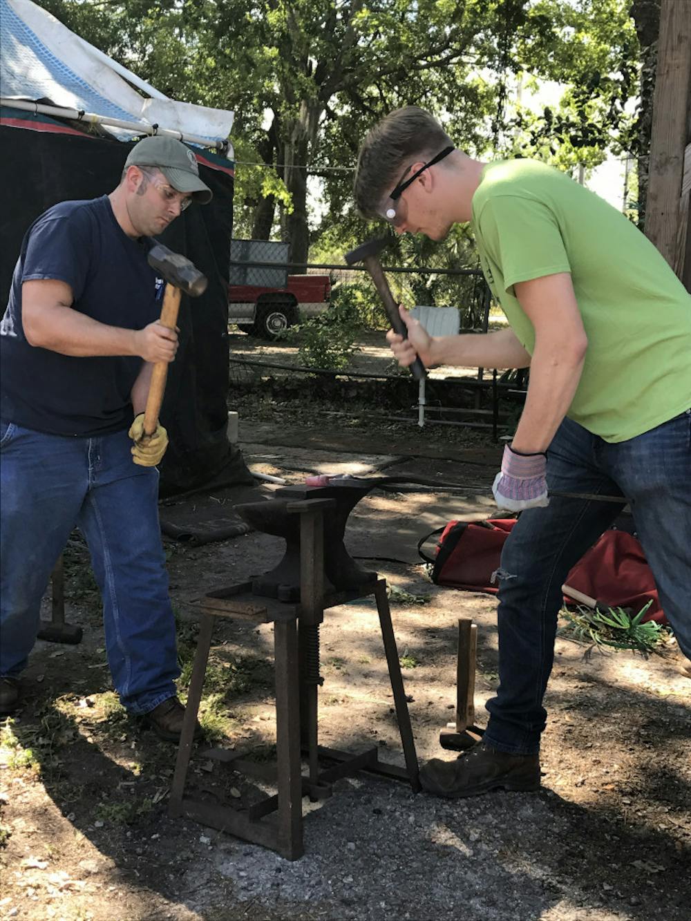 <p><span>Thirty-one-year-old John Carter (left) and 26-year-old Martin Kipp team up to mold their mall pein hammer into an axe using a technique called forging.</span></p>