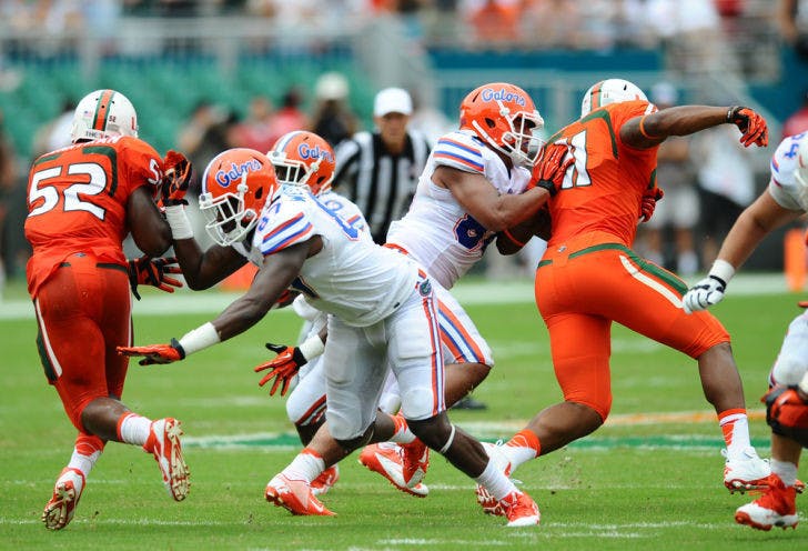 Junior tight ends Tevin Westbrook (87) and Clay Burton (88) block Miami defenders during Florida’s 21-16 loss to Miami on Saturday in Sun Life Stadium. UF has three offensive linemen dealing with injuries.