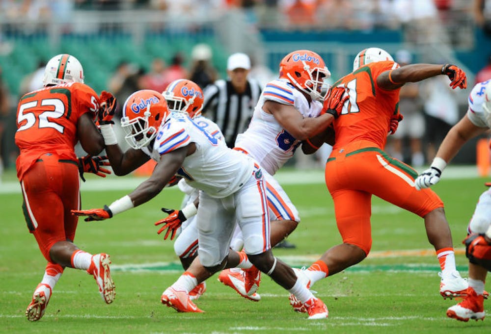 <p>Junior tight ends Tevin Westbrook (87) and Clay Burton (88) block Miami defenders during Florida’s 21-16 loss to Miami on Saturday in Sun Life Stadium. UF has three offensive linemen dealing with injuries.</p>