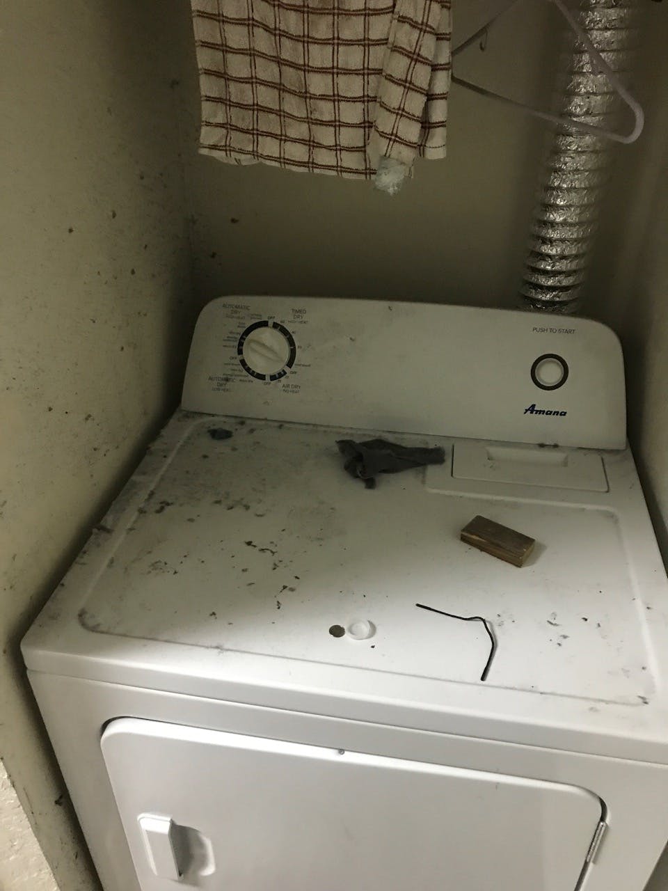 The washing machine in UF political science junior Herman Younger’s Pavilion on 62nd Apartment is covered with dirt. Younger said his apartment wasn’t cleaned before he moved in.