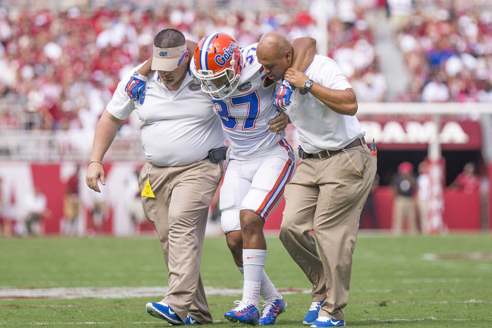 <p>Trainers carry UF running back Mark Herndon off the field during Florida's 42-21 loss to Alabama on Saturday at Bryant-Denny Stadium.</p>
