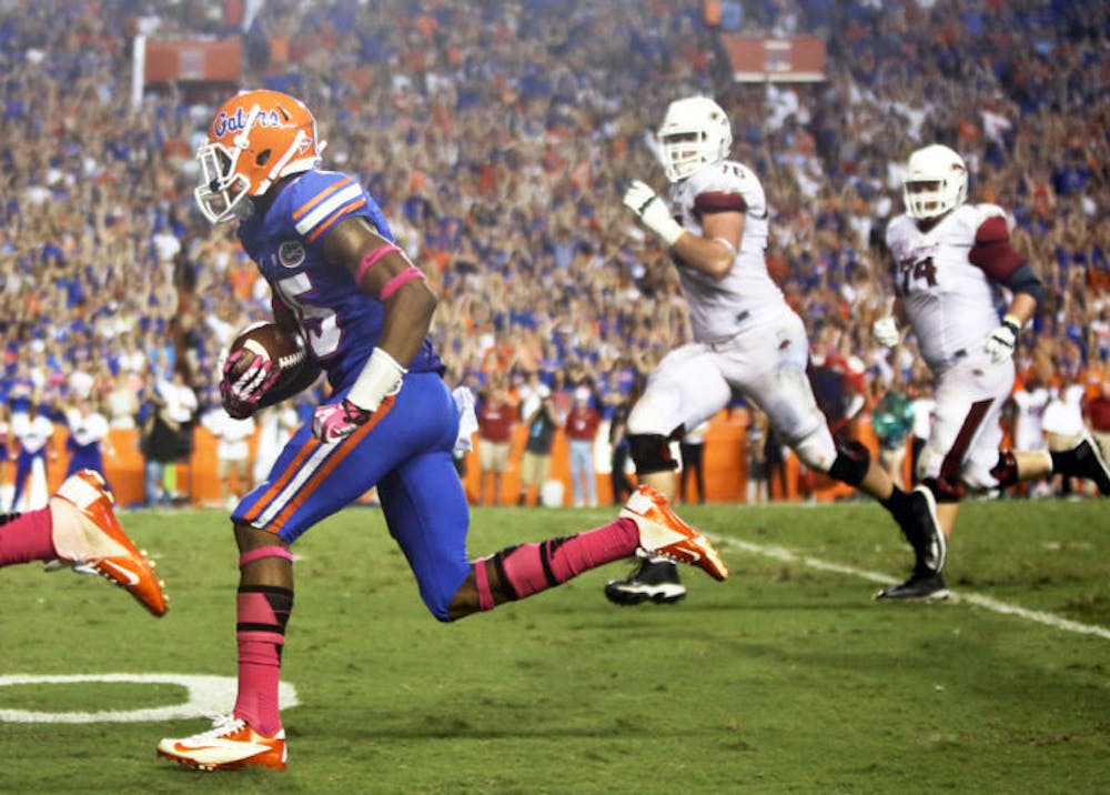 <p>Loucheiz Purifoy returns an interception 42 yards for a touchdown during Florida’s 30-10 victory against Arkansas on Saturday in Ben Hill Griffin Stadium. Florida forced two turnovers during the game.</p>