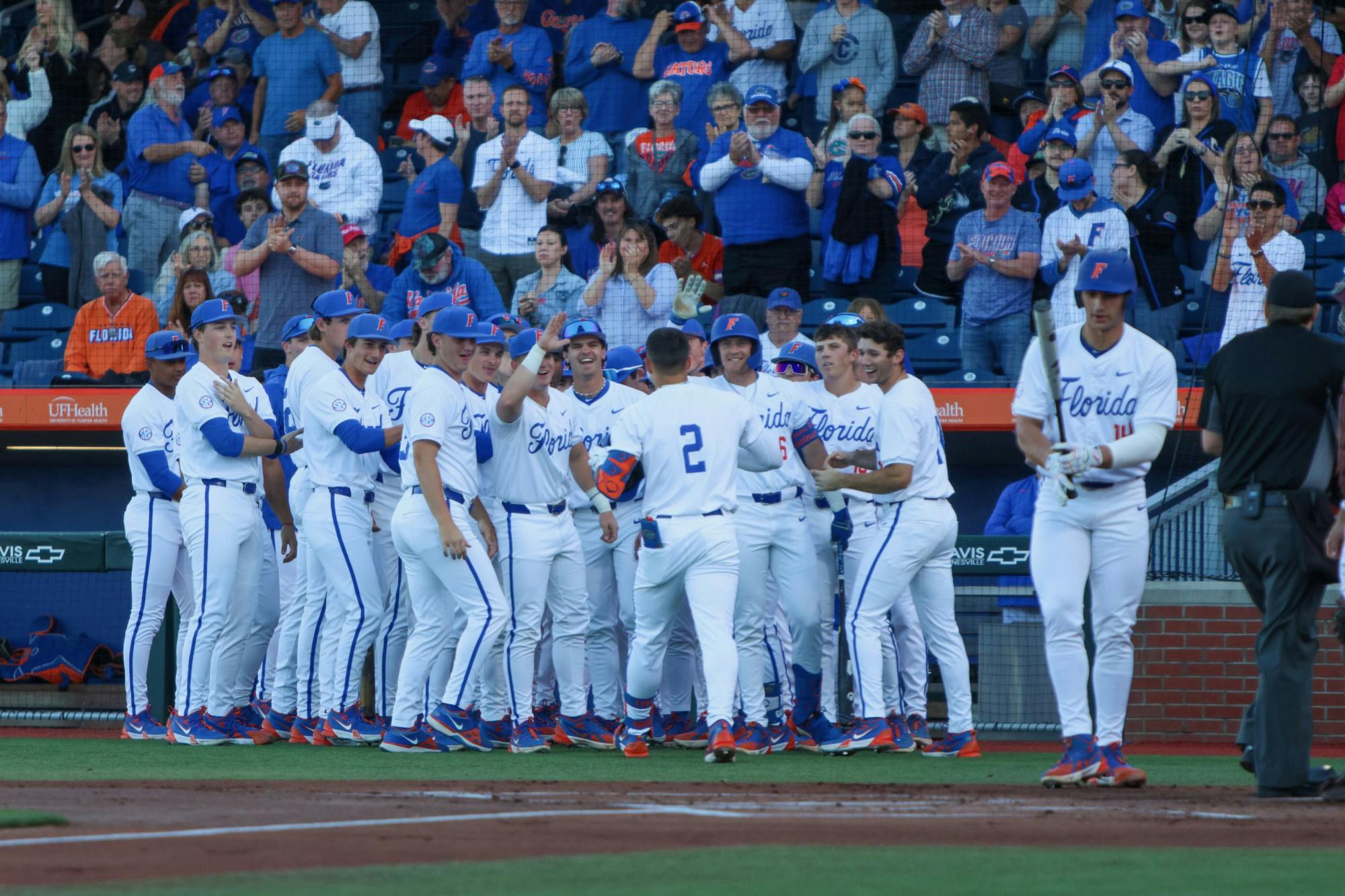 Junior Ty Evans meets his team after touching home plate after a home run in the bottom of the first inning in Game 1 of a three-game series against the Mississippi State Bulldogs Friday, March 29, 2024. 