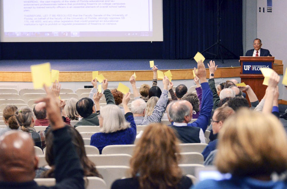 <p>Members of the UF faculty senate cast their vote to pass a resolution opposing concealed carry on Thursday in the Reitz Union Auditorium.</p>