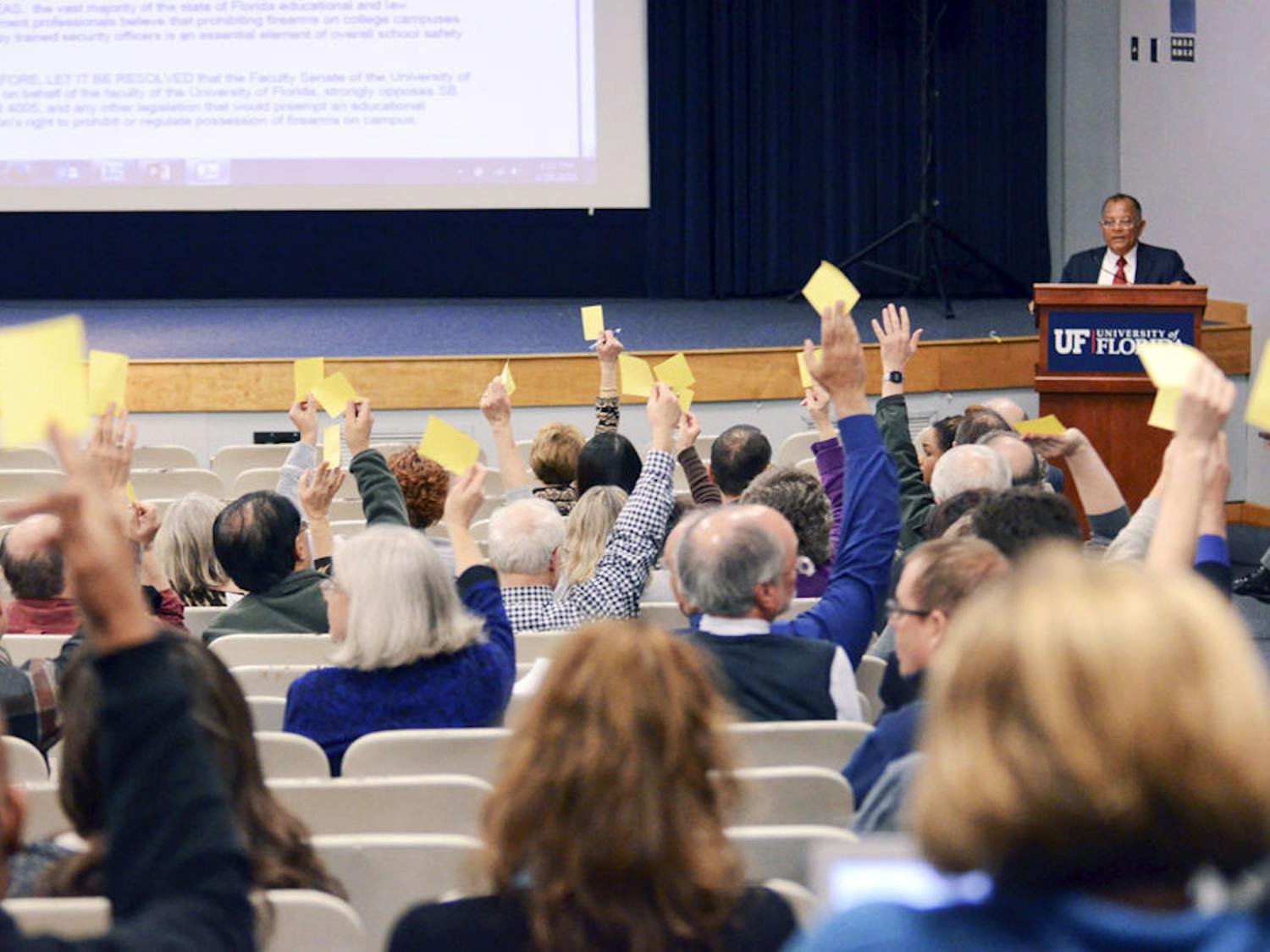 Members of the UF faculty senate cast their vote to pass a resolution opposing concealed carry on Thursday in the Reitz Union Auditorium.