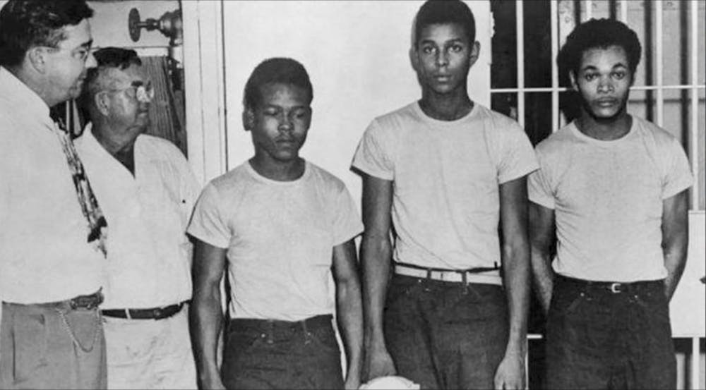 Lake County Sheriff Willis McCall, far left, and an unidentified man stand next to Walter Irvin, Samuel Shepherd and Charles Greenlee, from left, in Florida. The three men along with a fourth were charged with rape in 1949. Florida Gov. Ron DeSantis and a Cabinet granted posthumous pardons Friday, Jan. 11, 2019, to Shepherd, Irvin, Charles Greenlee and Ernest Thomas, the four  were charged with rape in 1949. Courtesy of Associated Press