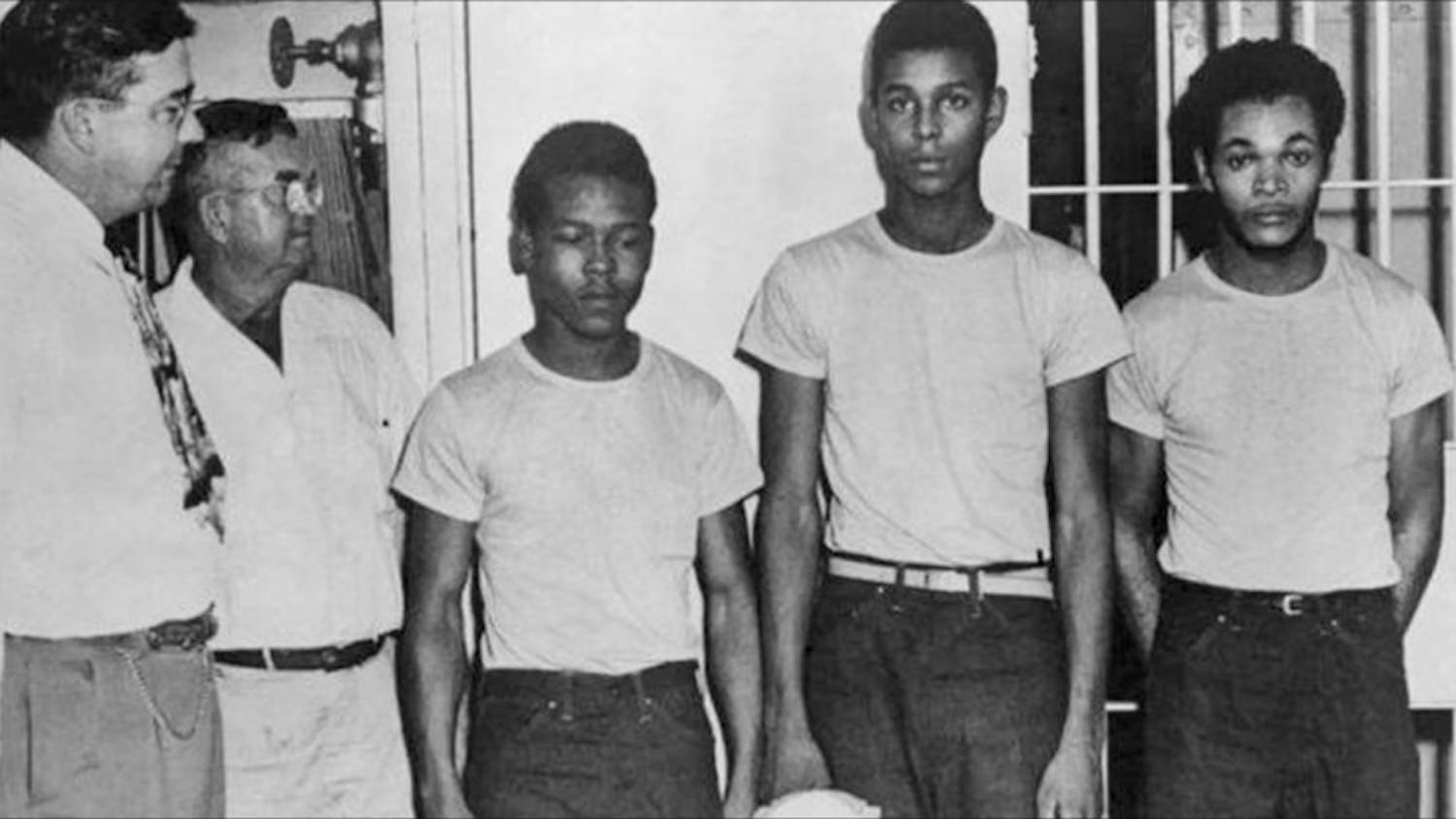 Lake County Sheriff Willis McCall, far left, and an unidentified man stand next to Walter Irvin, Samuel Shepherd and Charles Greenlee, from left, in Florida. The three men along with a fourth were charged with rape in 1949. Florida Gov. Ron DeSantis and a Cabinet granted posthumous pardons Friday, Jan. 11, 2019, to Shepherd, Irvin, Charles Greenlee and Ernest Thomas, the four  were charged with rape in 1949. Courtesy of Associated Press