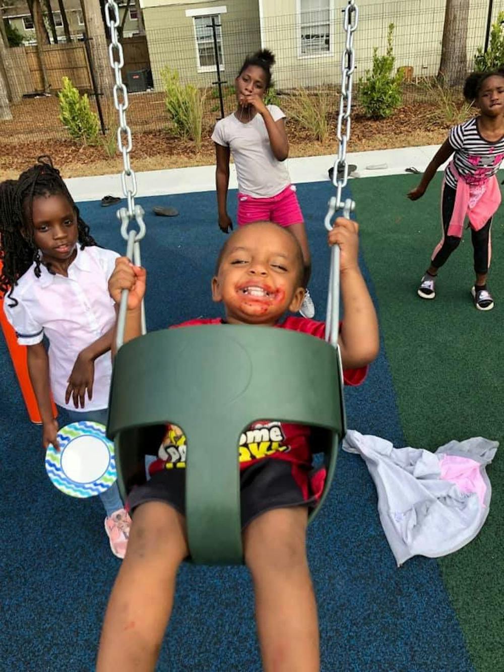 <p>Children play and run around the newly renovated Southwest Advocacy Group park, which was opened Wednesday at a ribbon-cutting ceremony.</p>