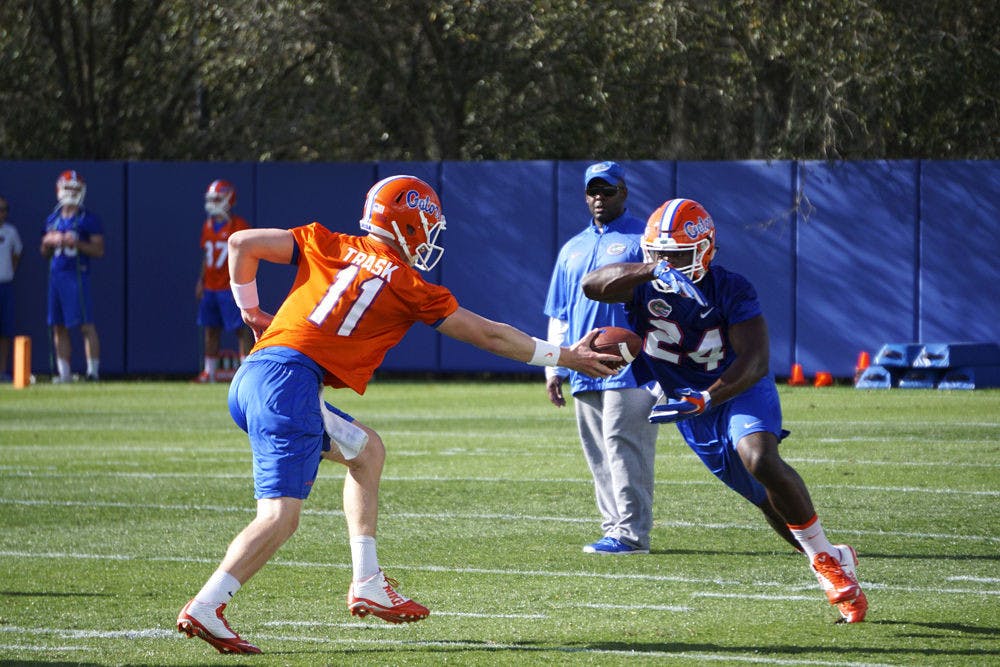 <p>Florida running back Mark Thompson takes a handoff from quarterback Kyle Trask during practice on March 9, 2016, at the Sanders Practice Fields.&nbsp;</p>