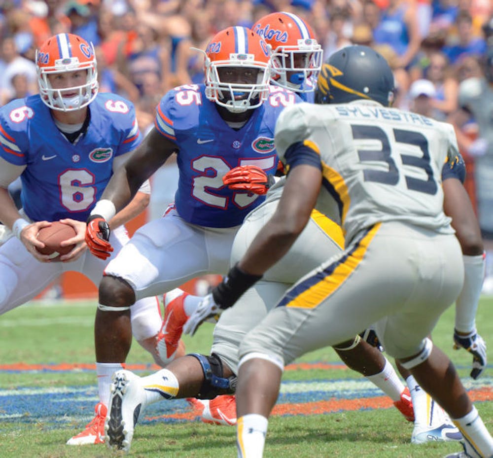 <p>Junior fullback Gideon Ajagbe (25) blocks during Florida’s 24-6 victory against Toledo on Saturday in Ben Hill Griffin Stadium. Ajagbe caught two passes for 16 yards in the game.</p>