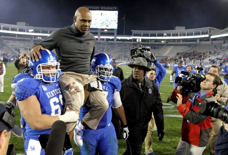 Fired Kentucky coach Joker Phillips, top, is carried off the field after UK’s 34-3 win against Samford on Nov. 17 in Lexington, Ky. Phillips was hired on Monday to coach Florida’s wide receivers.&nbsp;
