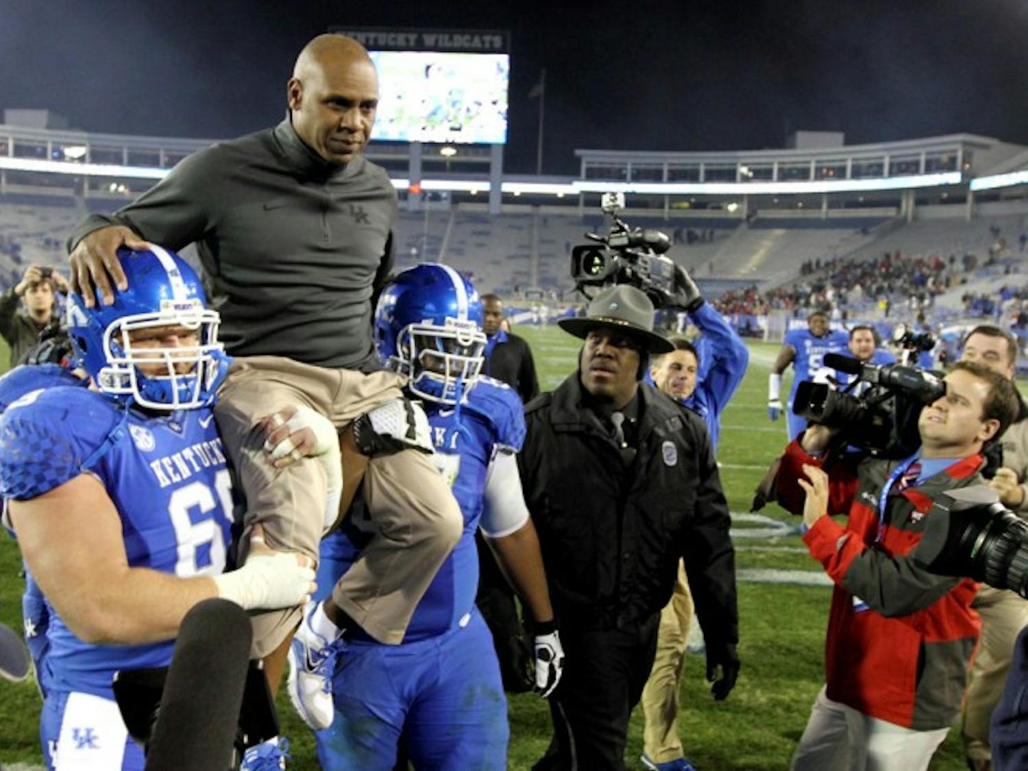 Fired Kentucky coach Joker Phillips, top, is carried off the field after UK’s 34-3 win against Samford on Nov. 17 in Lexington, Ky. Phillips was hired on Monday to coach Florida’s wide receivers. 