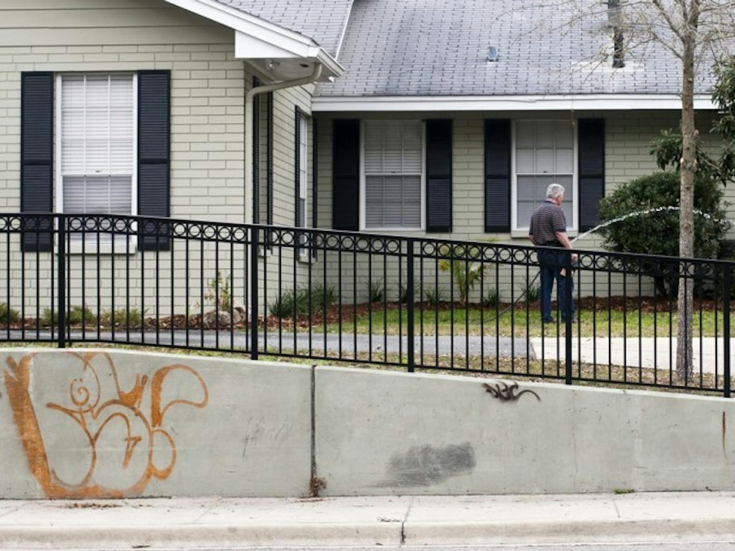 Graffiti covers the wall in front of a house on University Avenue on Thursday. In response to increased amounts of graffiti, spokesman Bob Woods said the city has developed a campaign to raise public awareness toward the issue and minimize the unwelcome marks. The campaign will be unrolled this month.