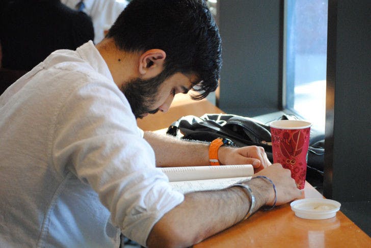 Sundeep Singh, 20, drinks coffee while studying at the Library West Starbucks on Wednesday afternoon. Recent studies suggest people do not regularly consume coffee during the hours that would have the strongest effect.