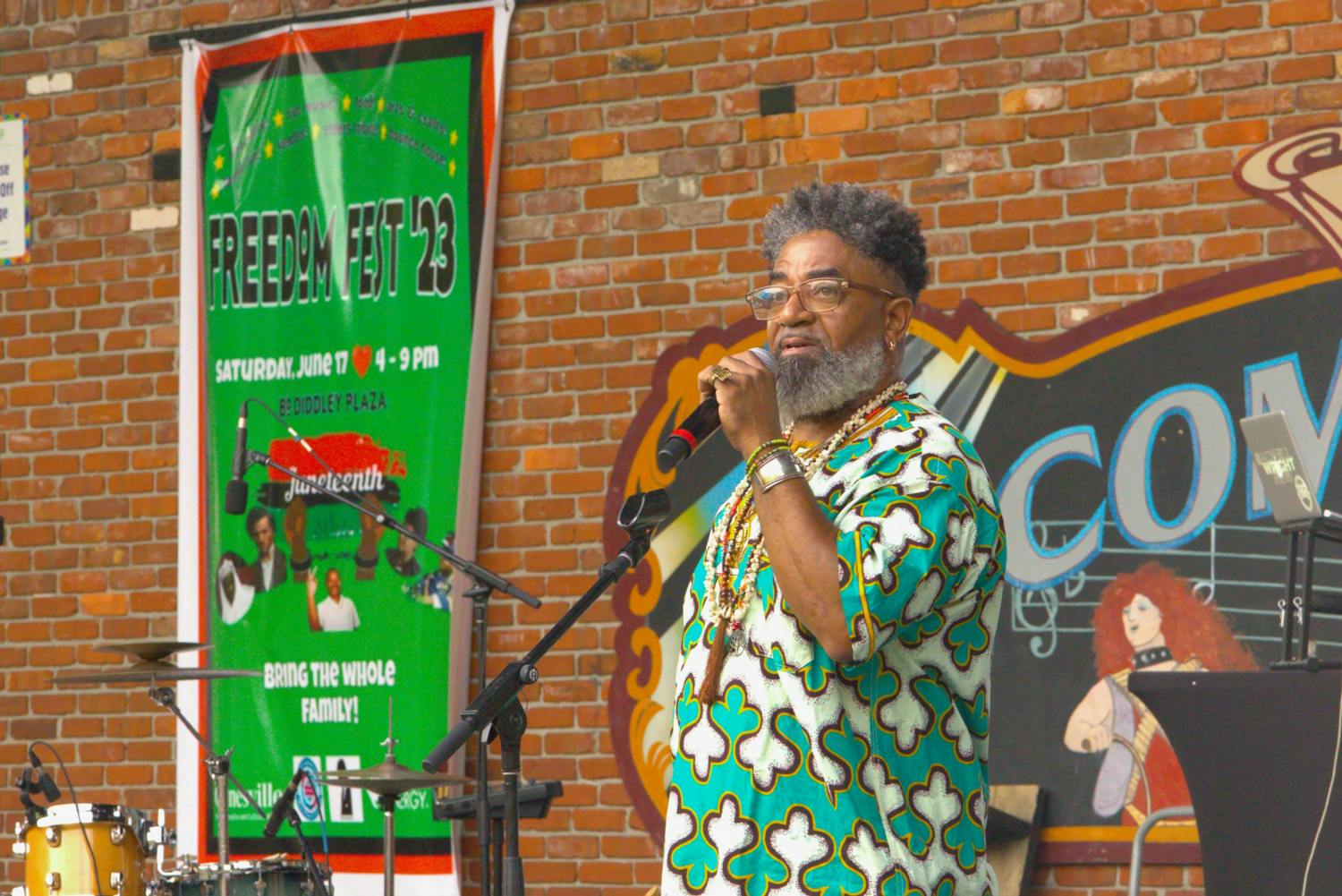 Turbado Marabou, a Yoruba Priest, gives a speech about ancestry at the Bo Diddley Plaza on Saturday, June 17, 2023. Marabou performed a libation, a spiritual ceremony where he poured liquid into a bowl.  