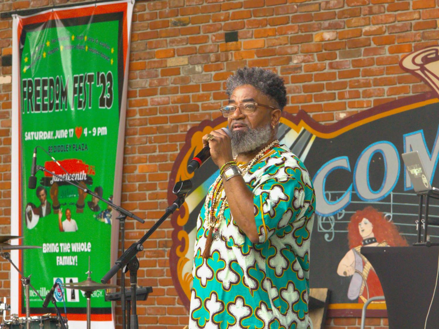Turbado Marabou, a Yoruba Priest, gives a speech about ancestry at the Bo Diddley Plaza on Saturday, June 17, 2023. Marabou performed a libation, a spiritual ceremony where he poured liquid into a bowl.