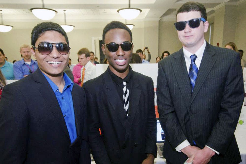 <p>From left: Hammaad Saber, a 21-year-old UF industrial systems engineering junior, Jerry DeClasse and Ben Vance, a 21-year-old UF industrial systems engineering junior, pose for a picture.</p>