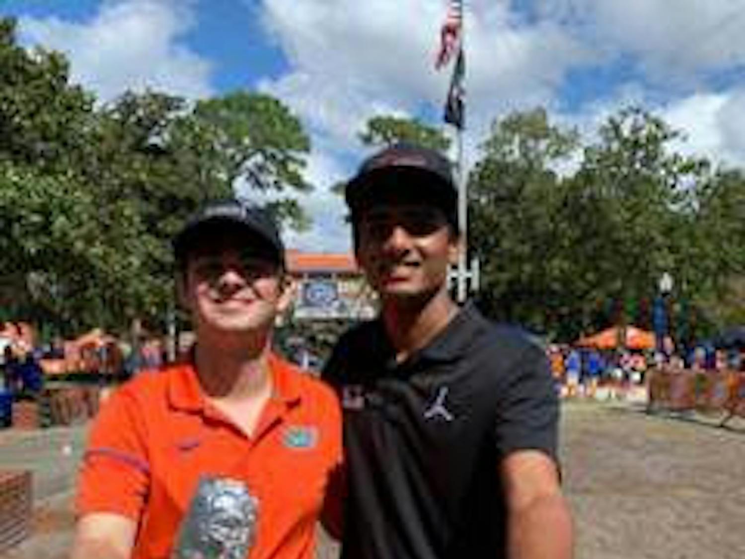 Pawan Badisa (right) poses with the Chipotle given to him at Century Tower after his sign was shown on ESPN's College GameDay. He received a DM from Chipotle letting him know his order was waiting for him at the tower and that he would be given free Chipotle for a year.