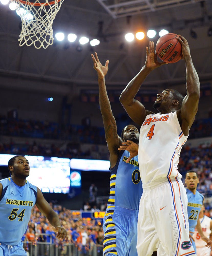 Patric Young attempts a shot during UF’s 82-49 win against Marquette on Thursday in the O’Connell Center. Young scored 10 points and grabbed 10 rebounds off the bench. 