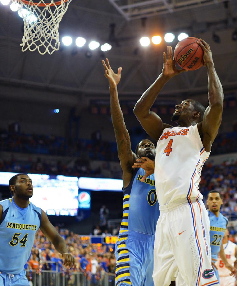 <p><span>Patric Young attempts a shot during UF’s 82-49 win against Marquette on Thursday in the O’Connell Center. Young scored 10 points and grabbed 10 rebounds off the bench. </span></p>