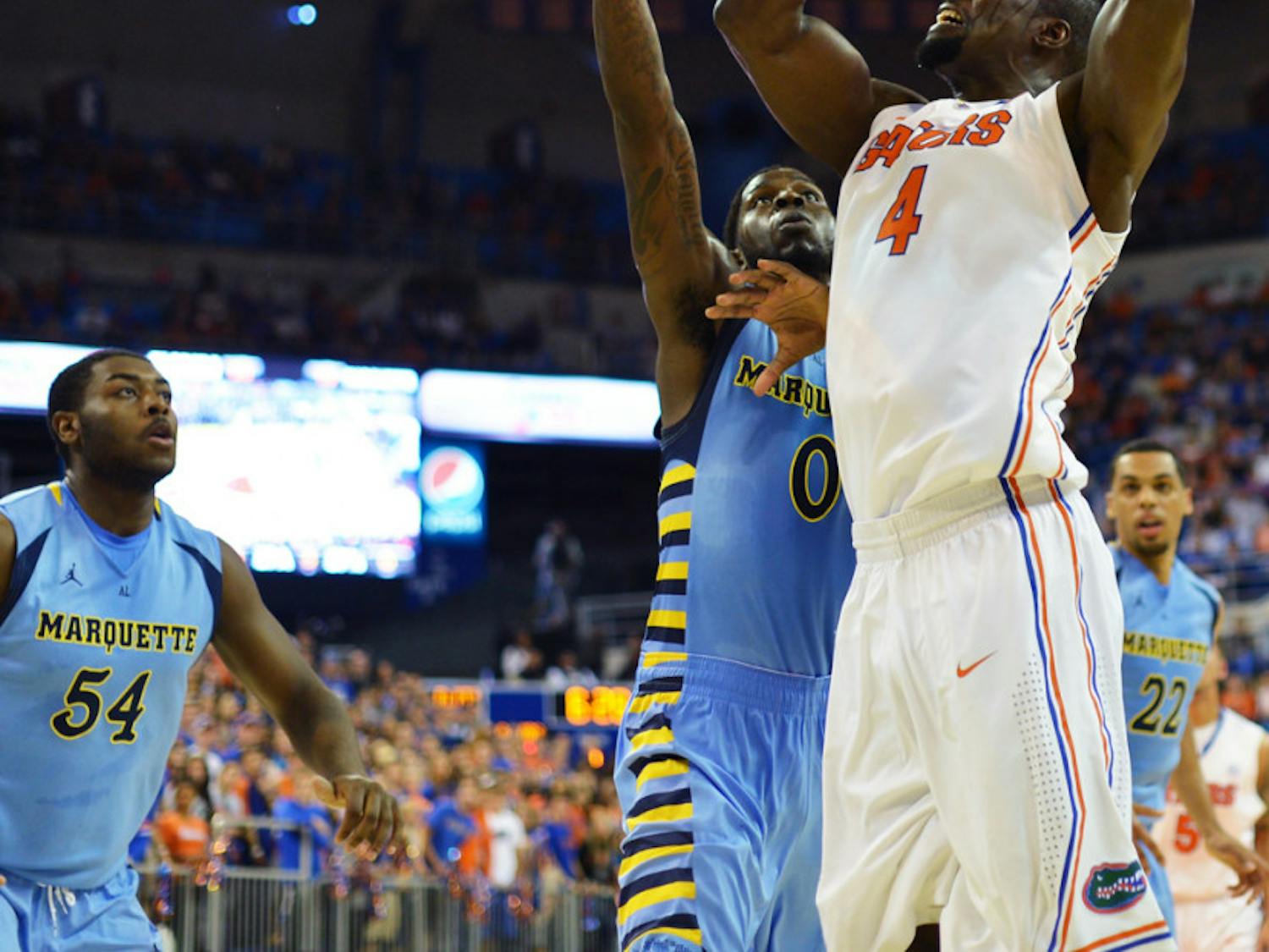 Patric Young attempts a shot during UF’s 82-49 win against Marquette on Thursday in the O’Connell Center. Young scored 10 points and grabbed 10 rebounds off the bench.