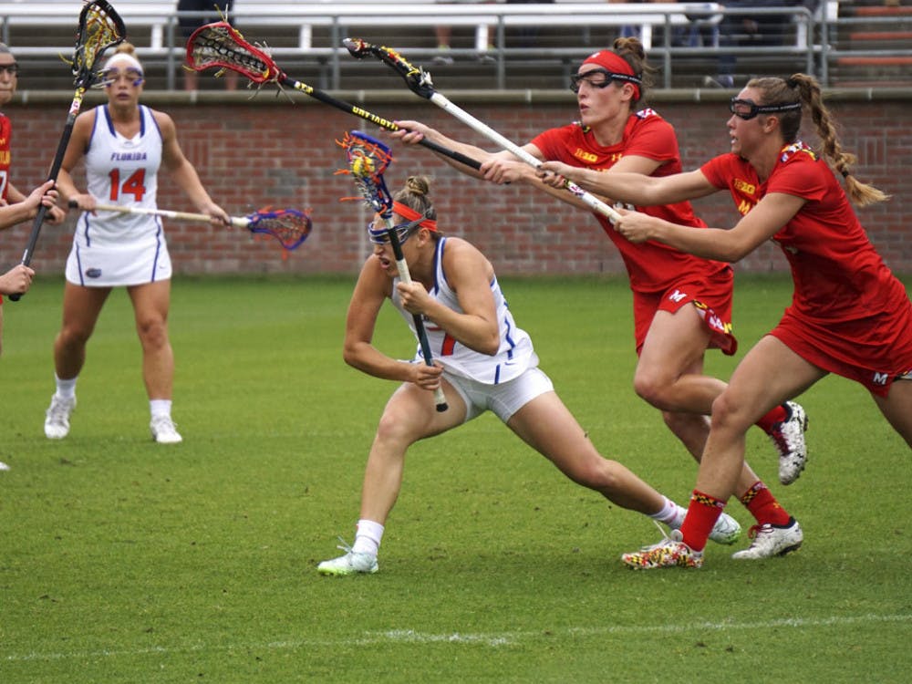 Shayna Pirreca (center) dodges defenders during Florida's 14-4 loss to Maryland on March 19, 2016, at Donald R. Dizney Stadium.