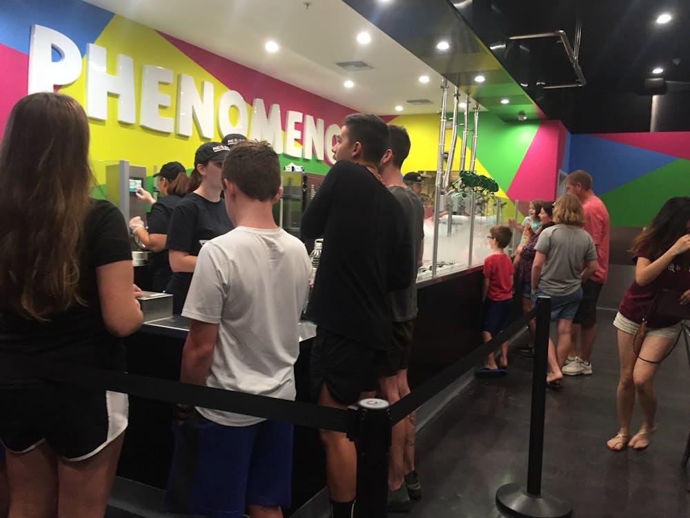 <p>Customers stand in line for the grand opening of Phenomenom Nitrogen Ice Cream and Bake Shop</p>