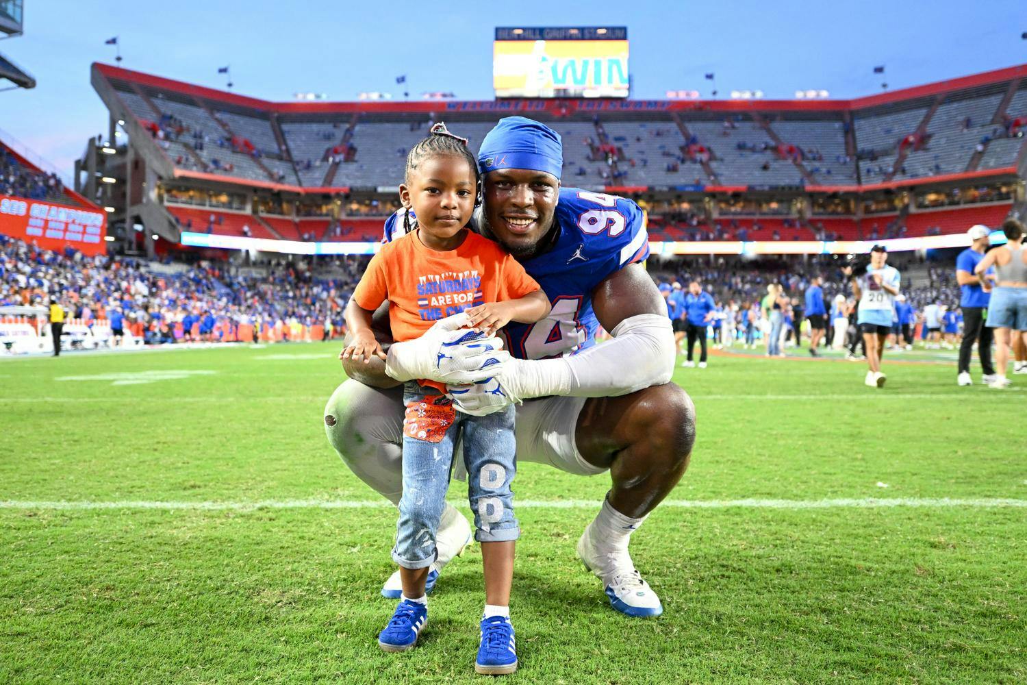 Florida Gators edge rusher Tyreak Sapp (94) stands with his daughter after a football game between the Texas Longhorns and the Florida Gators on Saturday, Oct. 4th, 2025, at Ben Hill Griffin Stadium in Gainesville, Fla.