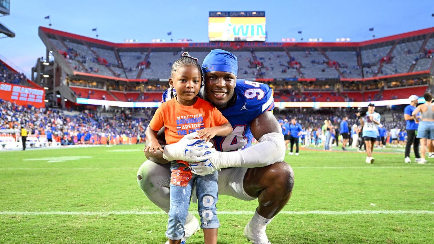 Florida Gators edge rusher Tyreak Sapp (94) stands with his daughter after a football game between the Texas Longhorns and the Florida Gators on Saturday, Oct. 4th, 2025, at Ben Hill Griffin Stadium in Gainesville, Fla.